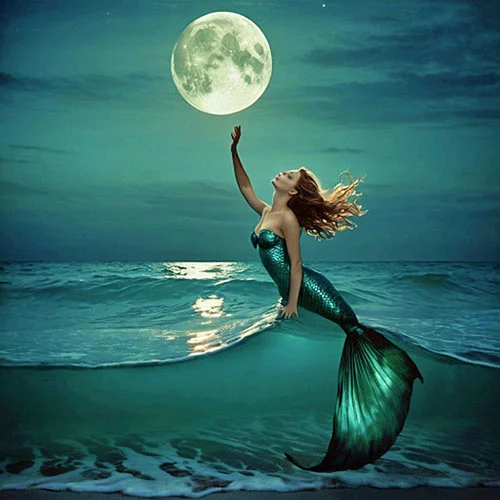 Digital artwork of a mermaid with flowing hair reaches out towards a glowing full moon as she emerges from the ocean waves.